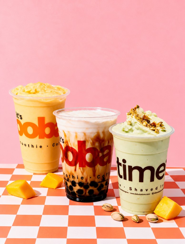 Studio shot of mango, brown sugar, and pistachio boba drinks on a checkered surface