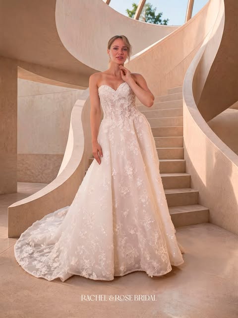 Bride posing outdoors in a lace wedding dress